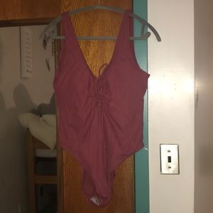 Pink lace up one piece bathing suit. Never worn